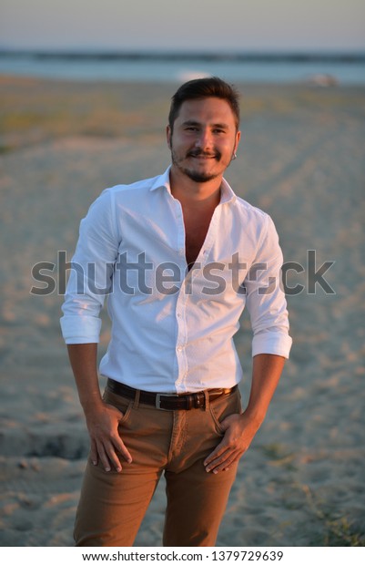 portrait of man
wearing white shirt at the
beach
