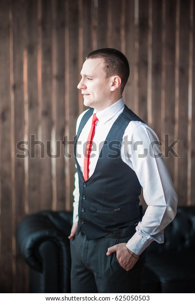 black vest white shirt red tie