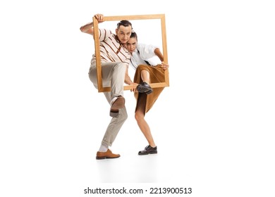 Portrait of man and woman appearing from picture frame, posing isolated over white background. Retro style. Concept of news, style, fashio, business, office lifestyle, success, expression, ad