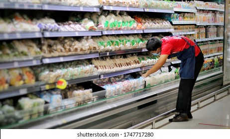 Portrait Of A Man Is Worker Or Staff Dairy Stocking Or Checking Food Products At Supermarket Or Store