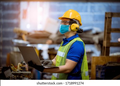 Portrait man worker under inspection and checking production process on factory station by wearing safety mask to protect for pollution and virus in factory.