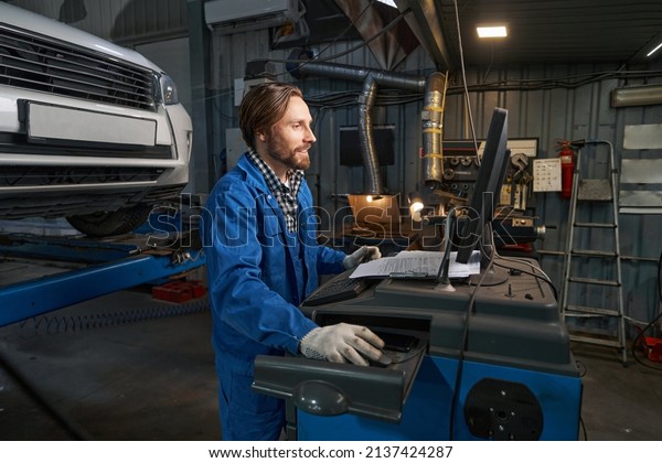 Portrait of\
man working at computer in service\
center