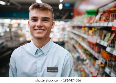 Portrait Of A Man Working In A Grocery Store. Male Supermarket Worker Smiling At Camera.