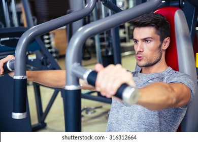 Portrait Of A Man Workout On Fitness Machine In Gym