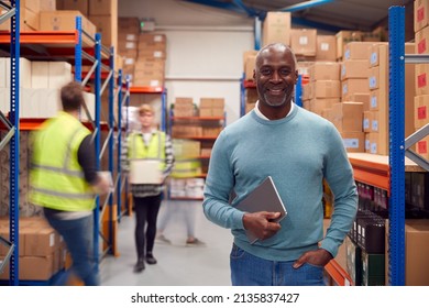 Portrait Of Manager With Digital Tablet In Busy Modern Warehouse With Staff In Background - Powered by Shutterstock