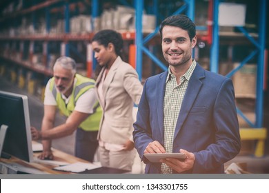 Portrait Of Manager Using Digital Table In Warehouse Office