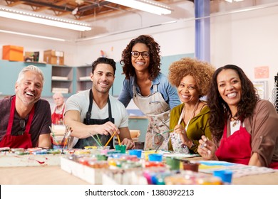 Portrait Of Mature Adults Attending Art Class In Community Centre With Teacher