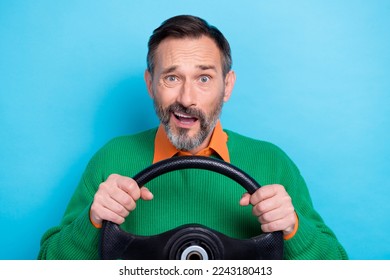 Portrait of mature aged grey hair man wear green jumper shirt driving new car steering wheel shocked accident isolated on blue color background