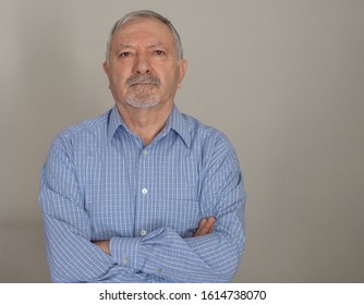 Portrait Of A Mature, Arms Crossed Man Looking At Camera At Indoor. Man With Goatee. Close Up Face Of A Serious Business Man.