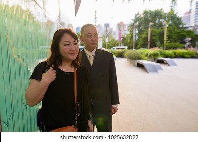 Portrait Of Mature Asian Businessman And Mature Asian Woman Exploring The City Of Bangkok, Thailand