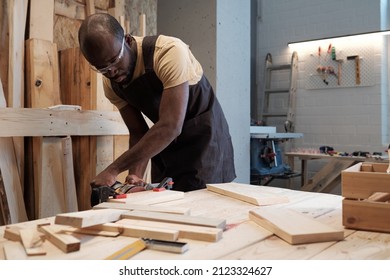 Portrait of mature black man building wooden furniture in carpentry workshop, copy space - Shutterstock ID 2123324627