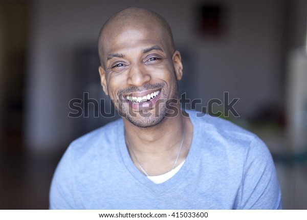 Portrait Of A\
Mature Black Man Smiling At\
Home