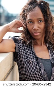 Portrait Of Mature Black Woman. She Has Curly Hair. Headshot.