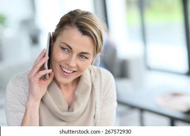 Portrait Of Mature Blond Woman Talking On Phone