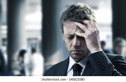 Portrait Of A Mature Business Man With Headache