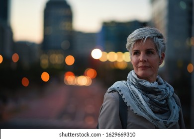 Portrait mature business woman looking confident city at night