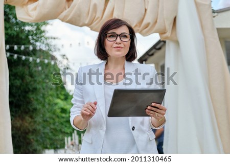 Portrait of a mature business woman small business owner organizing events, parties, weddings