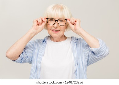 Portrait Of Mature Business Woman Smile While Standing Against White Background. Photo Of Old Woman Wearing Glasses. A Beautiful Modern Grandmother Is A Pensioner.