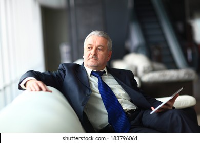 Portrait of a mature businessman with digital tablet - Powered by Shutterstock