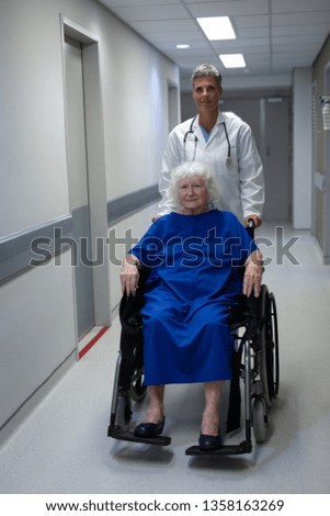 Similar – Doctor talking to elderly patient in a wheelchair