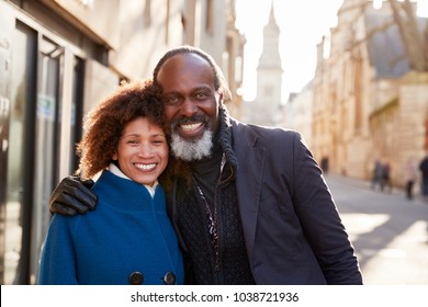 Portrait Of Mature Couple Walking Through City In Fall Together