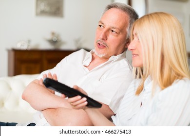 Portrait Of A Mature Couple Watching Television