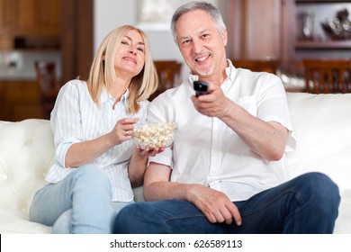 Portrait of a mature couple watching television - Shutterstock ID 626589113