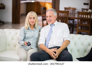 Portrait Of A Mature Couple Watching A Tv Show At Home