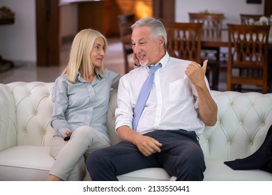 Portrait Of A Mature Couple Watching A Tv Show At Home