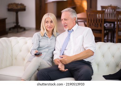 Portrait Of A Mature Couple Watching A Tv Show At Home