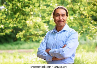 Portrait Of A Mature Dark Skin Man Standing With Arms Crossed 