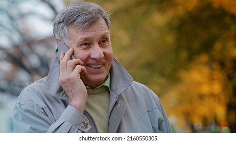 Portrait Mature Elderly Man Pensioner Communicate Remotely Using Modern Smartphone Talking Family Or Friends Order Delivery Happy Old Senior Laughing Outdoors Discussing Good Health With Family Doctor