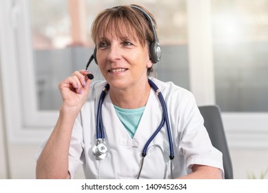 Portrait Of Mature Female Doctor During Online Medical Consultation