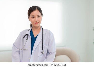 Portrait of Mature Female Doctor Wearing white Coat with Stethoscope Standing in Hospital Corridor. Concept Of Medical Technology and Healthcare Business. - Powered by Shutterstock