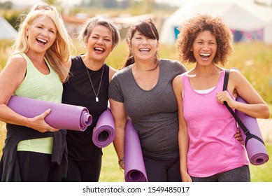 Portrait Of Mature Female Friends On Outdoor Yoga Retreat Walking Along Path Through Campsite - Powered by Shutterstock