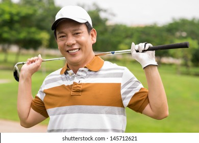 Portrait of a mature golf player smiling and looking at camera