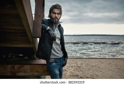 Portrait of a mature handsome man resting on the autumn beach