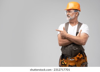 portrait of mature happy handyman presenting something isolated on white background