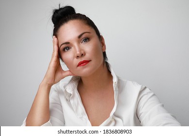 Portrait Of Mature Hispanic Woman With Red Lips, Posing And Smiling Over White Background.