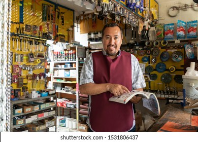 Portrait Of Mature Latin Entrepreneur Man With Retail Business Background.