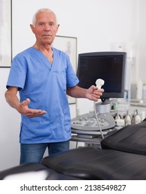 Portrait Of Mature Male Sonographer Doctor In Uniform In Medical Diagnostics Office