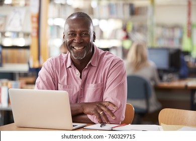 Portrait Of Mature Male Student Using Laptop In Library - Powered by Shutterstock