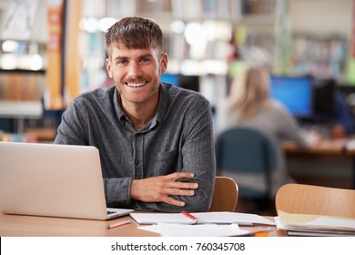 Portrait Of Mature Male Student Using Laptop In Library