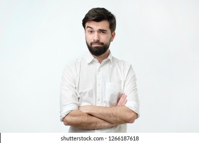 Portrait Of A Mature Man With A Beard Looking Suspicious. Person Lifts His Eyebrow And Do Not Really Believe In The Words He Hears, Looking A Little Bit Gloomy.