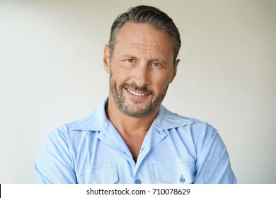 Portrait of mature man with blue shirt, isolated