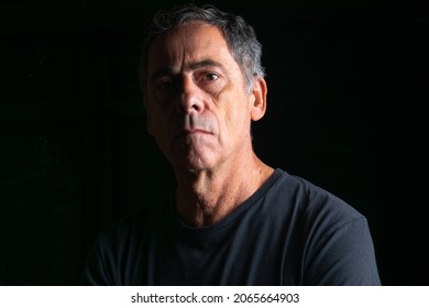 Portrait Of Mature Man .Half Illuminated Face