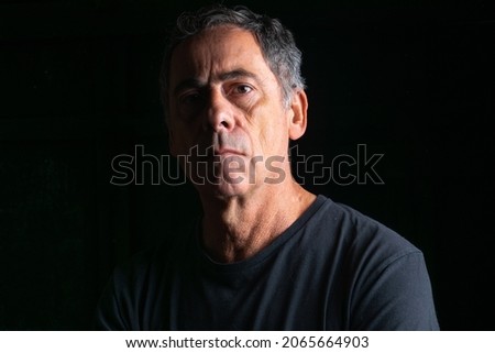 Image, Stock Photo Dramatic portrait of Black adult man looking up into spotlight while standing on stage in theater with low light copy space