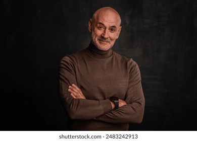 Portrait of mature man smiling to camera against isolated black background. Confident male wearing turtleneck sweater. - Powered by Shutterstock