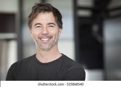 Portrait Of A Mature Man Smiling At The Camera. Home