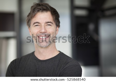 Portrait Of A Mature Man Smiling At The Camera. Home